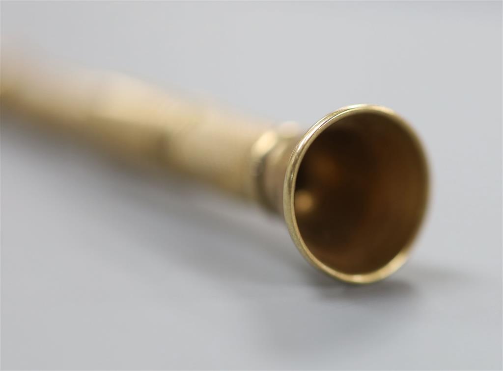 A mi 20th century engine turned 9ct gold cased cigar piercer, 67mm, gross 8.6 grams.